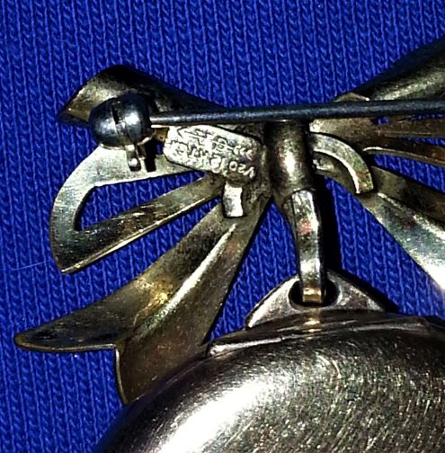 Stamp on back of watch pin
